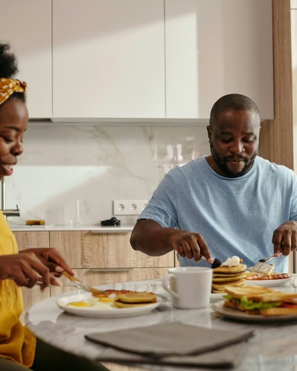 A couple sharing a fresh breakfast together at a sunlit kitchen table