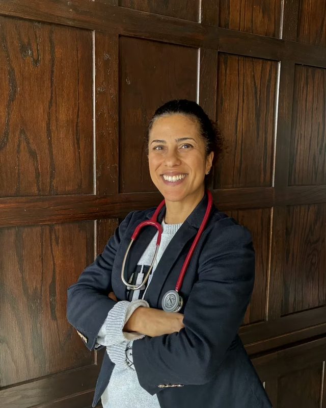 Dr Fabiolla Kopp in a navy blazer and stethoscope, smiling